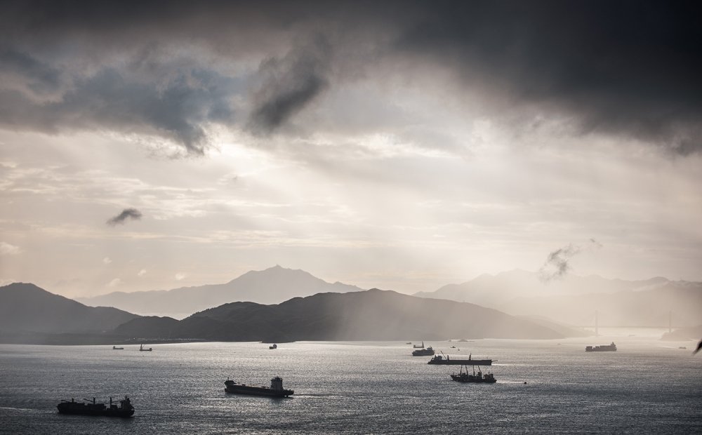 Container ships in the ocean at sunset.