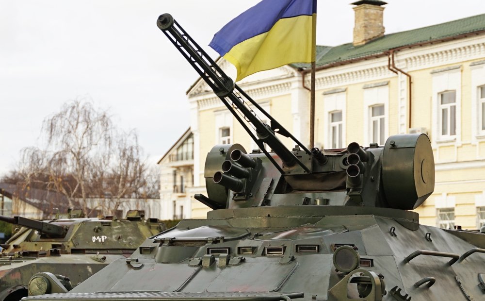 Army troops transporter and tank with Ukrainian flag, Ukraine