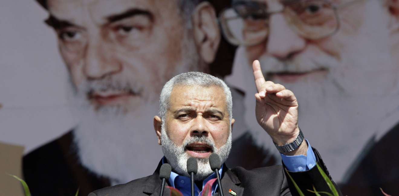 Visiting Hamas prime minister from Gaza, Ismail Haniyeh, gestures as he delivers his speech in front of portraits of late Iranian revolutionary founder Ayatollah Khomeini, left, and supreme leader Ayatollah Ali Khamenei, at a rally in Tehran.