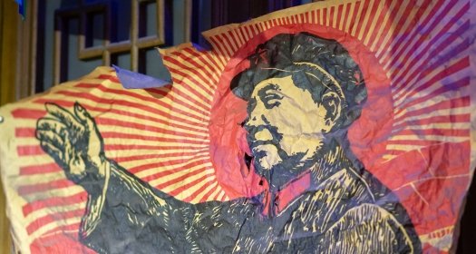 A tattered poster depicting Mao Zedong