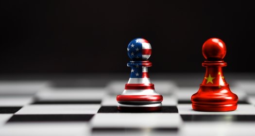 Two chess pieces representing the U.S. and China facing off.