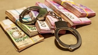 Iimage of Ukrainian hryvnia and handcuffs