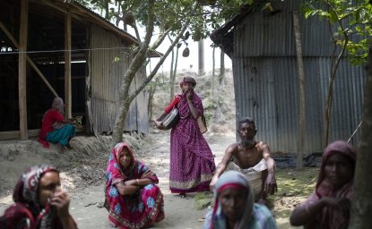 Bangladesh villagers sitting on ground