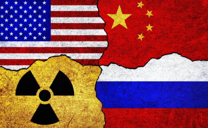 Flags of USA, Russia, China and radiation symbol on a wall.