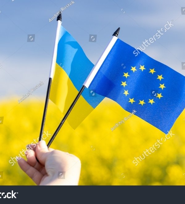 Flags with symbols of the European Union and Ukraine held in a girl's hand, Concept, Acceptance of the Ukrainian candidacy to apply for EU membership