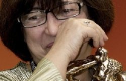 Close up of an older woman wiping away a tear