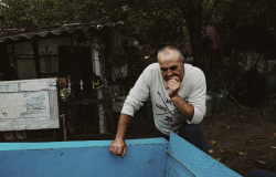 Ukrainian man leaning over blue trough