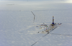 Oil, gas industry. Excellent drilling rig on the background of snow tundra. View from above