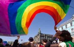 Saint-Petersburg, Russia - May 01, 2019: May demonstration. Marchers with a rainbow LGBT flag on Nevsky prospect.