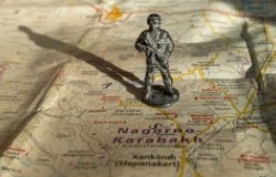 A figure soldier standing on a map of Nagorno-Karabakh