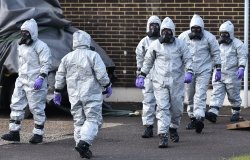 People in hazmat suits clean up the site of the poisoning of Sergei Skripal in Salisbury