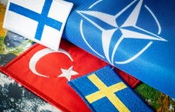 Turkish, Finnish, and Swedish flags next to a NATO flag