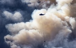  Wildfire Service Helicopter flying over BC Forest Fire.