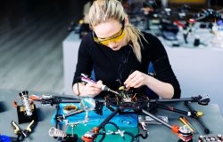 A woman engineer working on a racing drone.